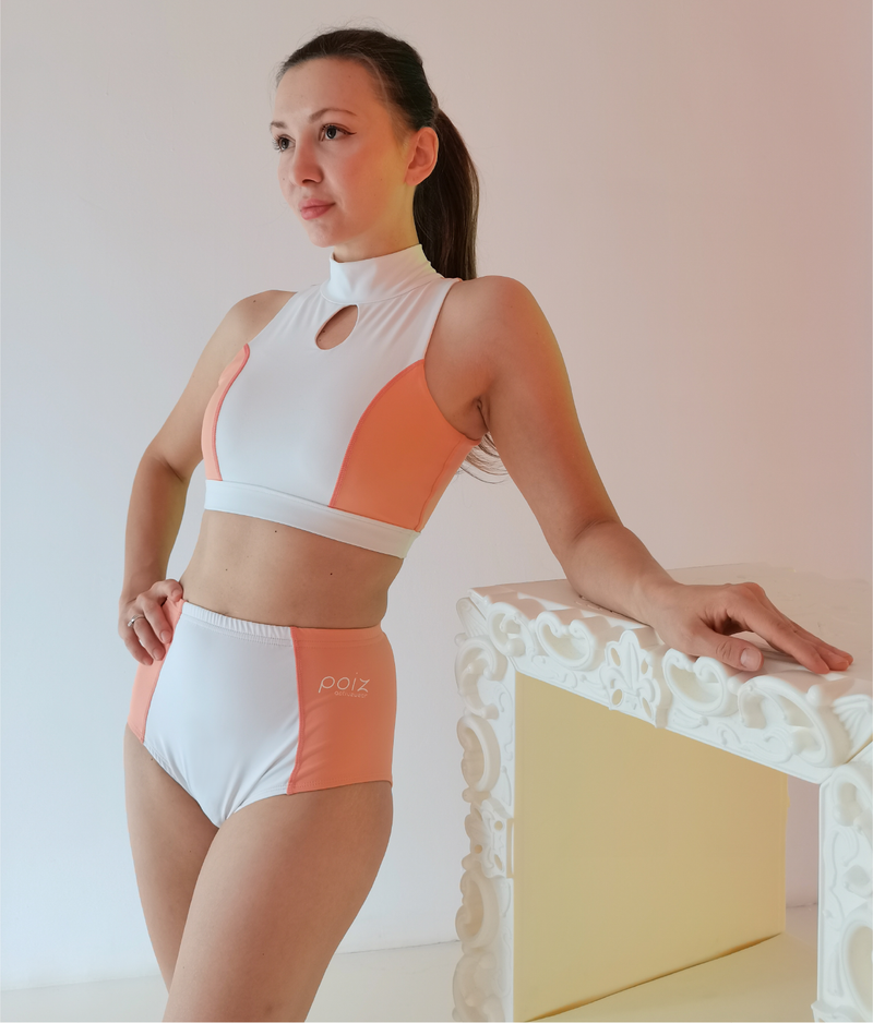 Brown Haired woman wearing Poiz Pole Dance Wear in Salmon-Pink and White colors